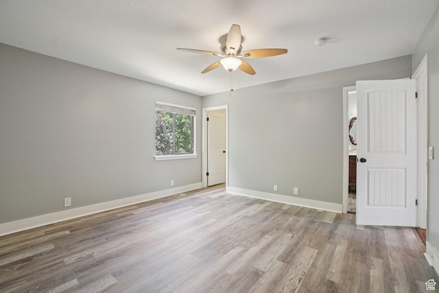 8892 S Flatiron Dr, Sandy, UT 84093 - spare room with ceiling fan, light wood-style floors, and a smoke detector