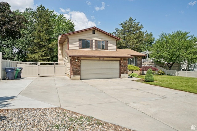 8892 S Flatiron Dr, Sandy, UT 84093 - split level home with a gate, driveway, an attached garage, and brick siding