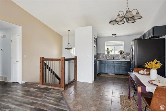 109 E 1875 N, Ogden, UT 84414 - kitchen featuring freestanding refrigerator, a chandelier, tasteful backsplash, light countertops, and pendant lighting