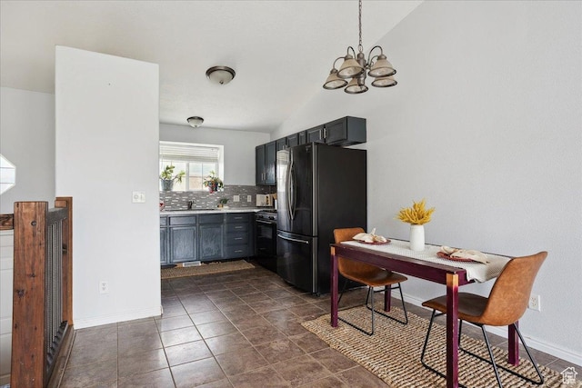 109 E 1875 N, Ogden, UT 84414 - kitchen with freestanding refrigerator, vaulted ceiling, black range with gas cooktop, backsplash, and a chandelier