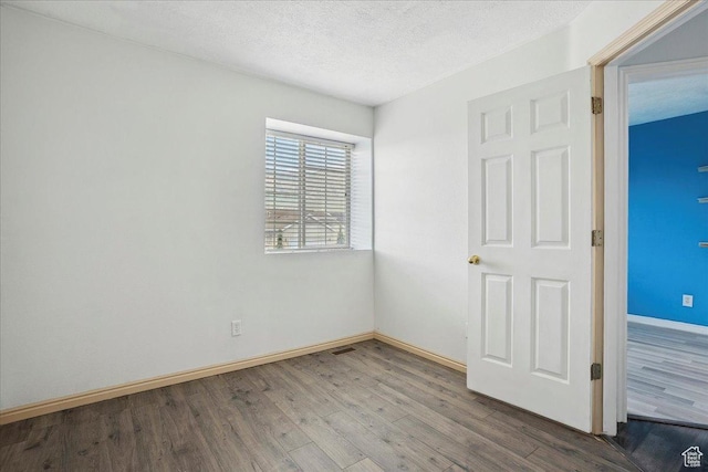 109 E 1875 N, Ogden, UT 84414 - unfurnished bedroom with wood finished floors and a textured ceiling