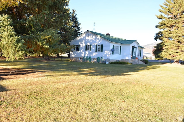 114 W 7th St, Georgetown, ID 83239 - view of side of home with a lawn and a chimney