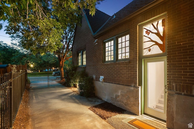 1710 E 900 S, Salt Lake City, UT 84108 - view of property exterior featuring brick siding, a shingled roof, and a gate