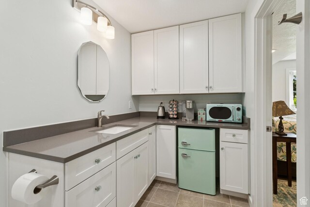 3922 View Pointe Dr, Park City, UT 84098 - kitchen featuring white appliances, dark countertops, white cabinetry, and light tile patterned flooring