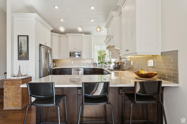 3922 View Pointe Dr, Park City, UT 84098 - kitchen with appliances with stainless steel finishes, a peninsula, white cabinets, and backsplash