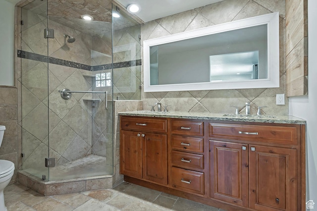 7669 S 1130 E, Midvale, UT 84047 - full bath featuring tile walls, double vanity, a shower stall, and stone tile flooring