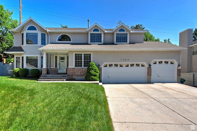 1222 E Big Pine Cir, Sandy, UT 84094 - view of front of house with stucco siding, a garage, concrete driveway, and a front yard