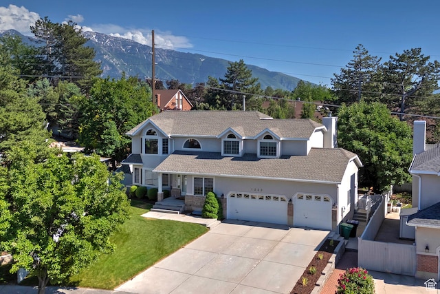 1222 E Big Pine Cir, Sandy, UT 84094 - view of front facade with concrete driveway, a garage, a mountain view, and stucco siding
