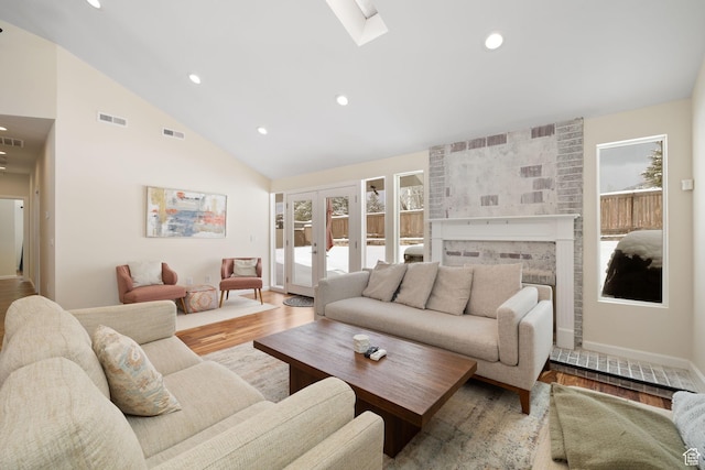 3569 E Avondale Dr S, Cottonwood Heights, UT 84121 - living area featuring wood finished floors, recessed lighting, high vaulted ceiling, a fireplace, and a skylight
