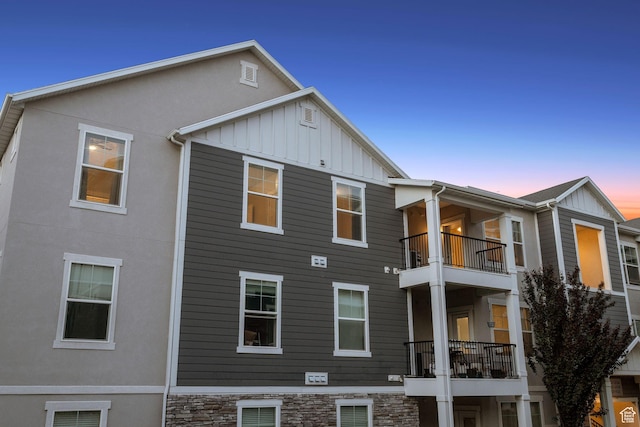 14654 S Bloom Dr W Unit K301, Herriman, UT 84096 - back of property at dusk featuring board and batten siding and stucco siding