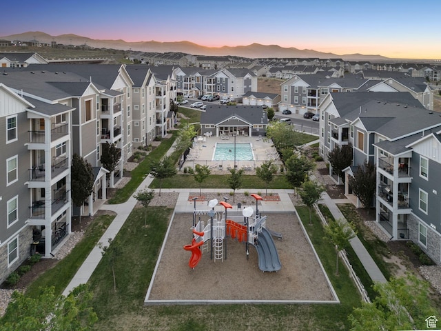 14654 S Bloom Dr W Unit K301, Herriman, UT 84096 - aerial view at dusk of view of pool area, a residential view, and a mountain view