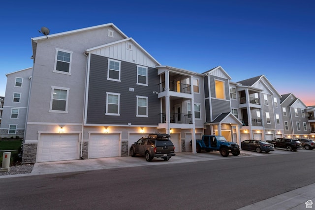 14654 S Bloom Dr W Unit K301, Herriman, UT 84096 - view of building exterior featuring an attached garage and driveway