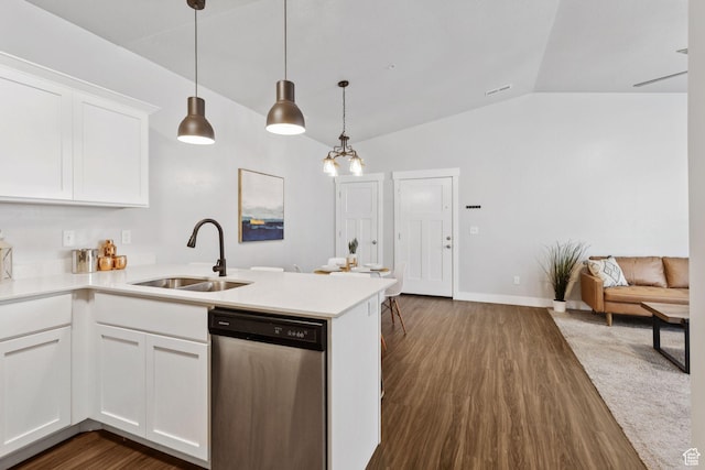 14654 S Bloom Dr W Unit K301, Herriman, UT 84096 - kitchen with stainless steel dishwasher, lofted ceiling, a peninsula, dark wood-type flooring, and white cabinetry