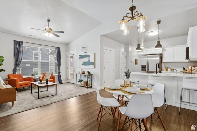 14654 S Bloom Dr W Unit K301, Herriman, UT 84096 - dining space featuring vaulted ceiling, wood finished floors, ceiling fan, and a chandelier