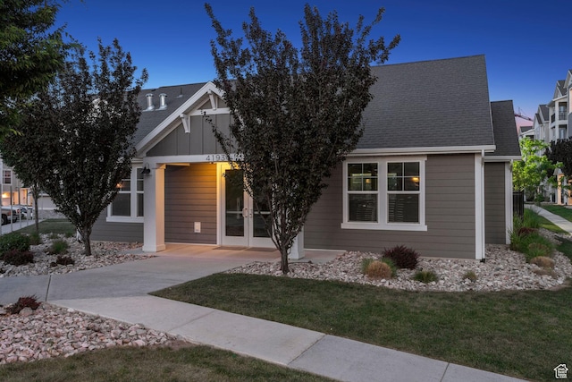 14654 S Bloom Dr W Unit K301, Herriman, UT 84096 - view of front of home with french doors, a front lawn, and a shingled roof
