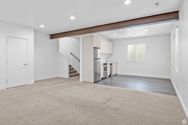 1046 W Albion Meadow Way, Bluffdale, UT 84065 - unfurnished living room with carpet, stairs, and recessed lighting