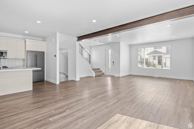 1046 W Albion Meadow Way, Bluffdale, UT 84065 - unfurnished living room featuring recessed lighting, light wood-style floors, and stairway