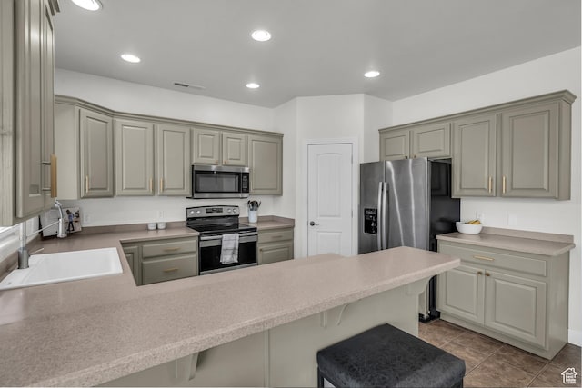 86 W 1965 S, Washington, UT 84780 - kitchen with stainless steel appliances, a peninsula, a breakfast bar, recessed lighting, and gray cabinets