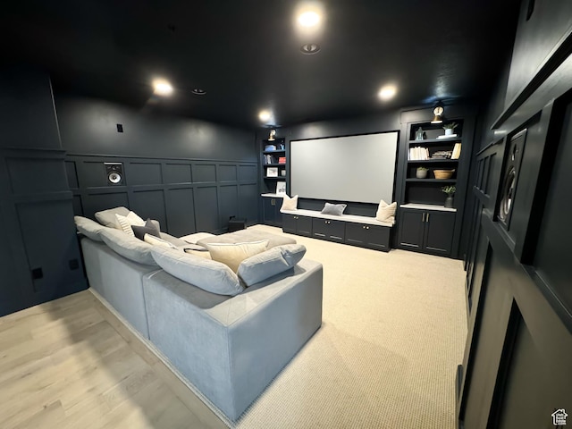 5469 N Meadow Lark Ln, Lehi, UT 84043 - cinema room with a decorative wall, built in shelves, wainscoting, and light wood-style flooring