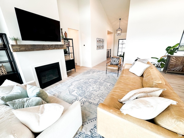 5469 N Meadow Lark Ln, Lehi, UT 84043 - living room with high vaulted ceiling, a fireplace, and light wood-style floors