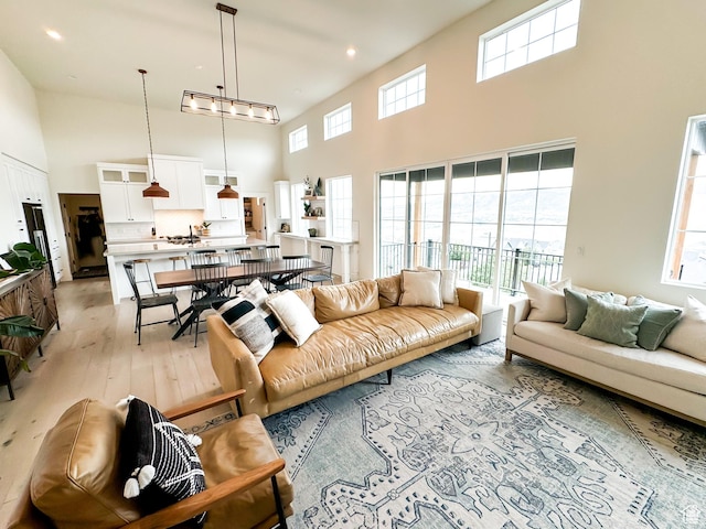5469 N Meadow Lark Ln, Lehi, UT 84043 - living area with a towering ceiling, light wood-style flooring, and recessed lighting