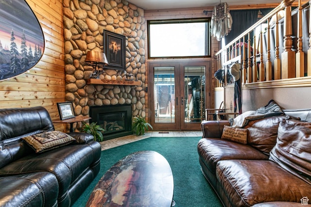 2462 W Hard Rock Cir, Taylorsville, UT 84129 - living room featuring carpet floors, a stone fireplace, and french doors