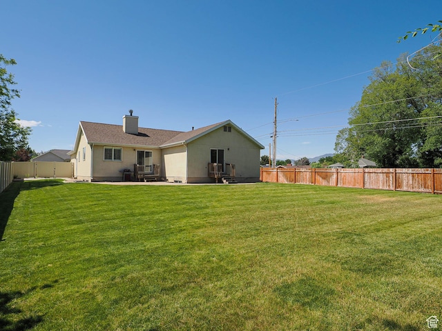 3988 W Sugar Beet Dr S, West Valley City, UT 84120 - back of property featuring a fenced backyard, a chimney, and a patio area