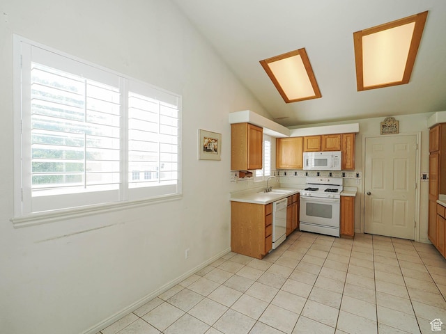 3988 W Sugar Beet Dr S, West Valley City, UT 84120 - kitchen with white appliances, vaulted ceiling, light countertops, light tile patterned floors, and brown cabinetry