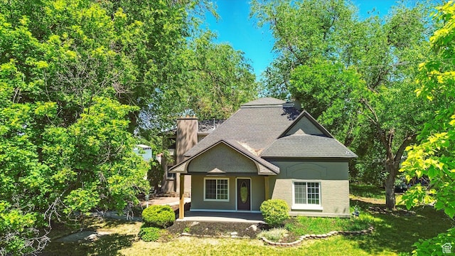 1655 W 2200 S, College Ward, UT 84339 - view of front of home featuring a chimney, a shingled roof, a porch, and stucco siding