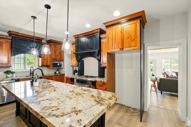 1655 W 2200 S, College Ward, UT 84339 - kitchen featuring appliances with stainless steel finishes, plenty of natural light, light stone countertops, decorative backsplash, and recessed lighting