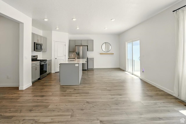 1147 E Fathom Ln, Saratoga Springs, UT 84045 - kitchen with appliances with stainless steel finishes, gray cabinets, recessed lighting, light countertops, and a center island with sink