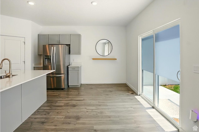 1147 E Fathom Ln, Saratoga Springs, UT 84045 - kitchen featuring stainless steel refrigerator with ice dispenser, gray cabinetry, wood finished floors, light countertops, and recessed lighting