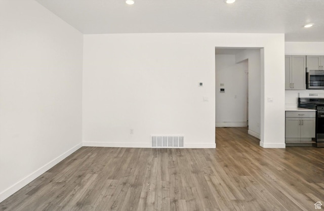 1147 E Fathom Ln, Saratoga Springs, UT 84045 - unfurnished living room with wood finished floors and recessed lighting