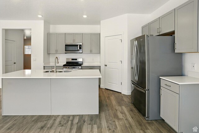 1147 E Fathom Ln, Saratoga Springs, UT 84045 - kitchen featuring appliances with stainless steel finishes, gray cabinetry, dark wood-type flooring, light countertops, and recessed lighting
