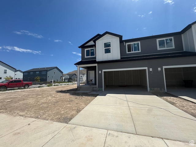 3646 N Oak Blvd Unit 322, Eagle Mountain, UT 84005 - view of front of property featuring a garage, concrete driveway, and a residential view