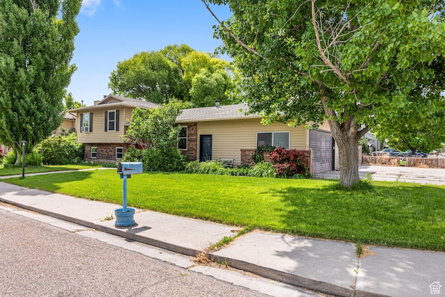 462 E 370 N, Delta, UT 84624 - view of front facade featuring a front yard, brick siding, and a garage