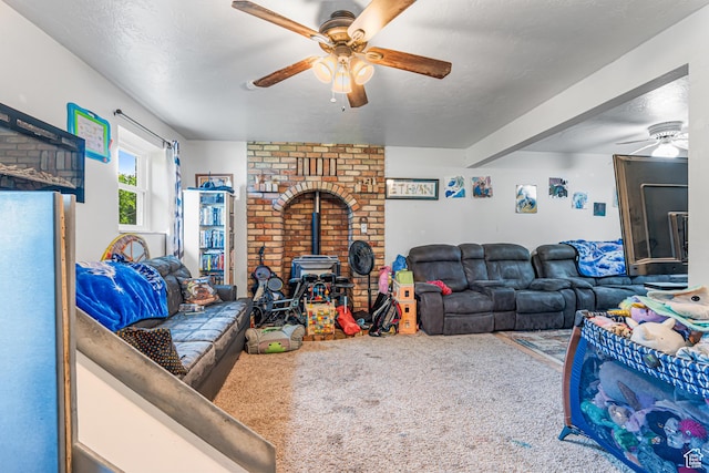 462 E 370 N, Delta, UT 84624 - living area featuring a ceiling fan, a wood stove, and carpet flooring