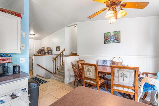 462 E 370 N, Delta, UT 84624 - dining space with ceiling fan, light tile patterned flooring, a wainscoted wall, stairway, and lofted ceiling