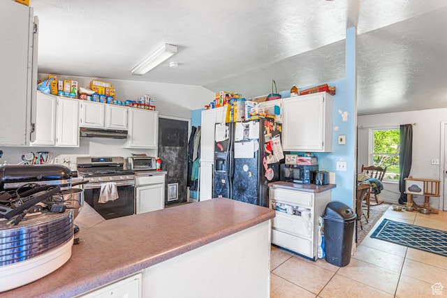 462 E 370 N, Delta, UT 84624 - kitchen with gas stove, lofted ceiling, light tile patterned floors, white cabinets, and under cabinet range hood