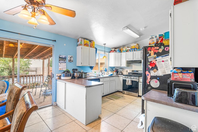 462 E 370 N, Delta, UT 84624 - kitchen featuring stainless steel gas range, under cabinet range hood, a peninsula, ceiling fan, and light tile patterned floors