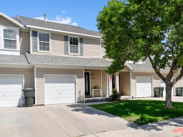 1738 N Brett St, Tooele, UT 84074 - townhome / multi-family property with a porch, a garage, concrete driveway, and a front yard
