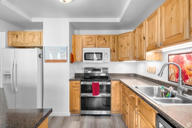 1738 N Brett St, Tooele, UT 84074 - kitchen featuring white appliances, wood finished floors, and dark countertops