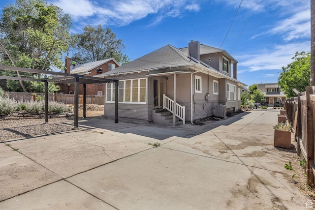 2546 S Fowler, Ogden, UT 84401 - rear view of house with entry steps, a patio, a shingled roof, and a fenced backyard