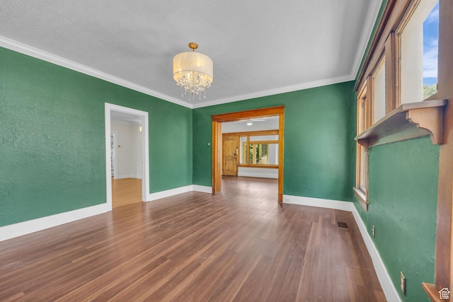 2546 S Fowler, Ogden, UT 84401 - spare room featuring a chandelier, wood finished floors, crown molding, and a textured wall
