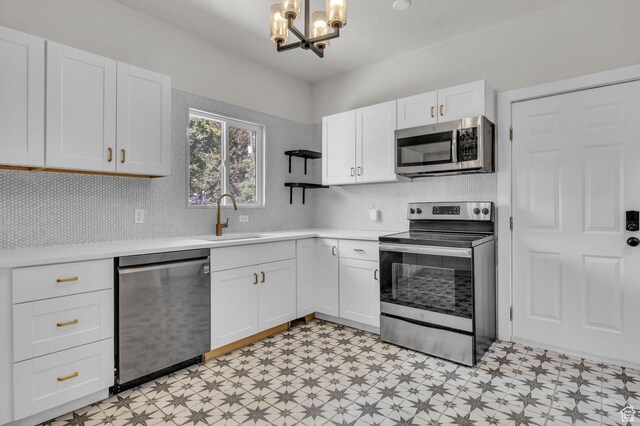 2546 S Fowler, Ogden, UT 84401 - kitchen with stainless steel appliances, light floors, a chandelier, open shelves, and light countertops