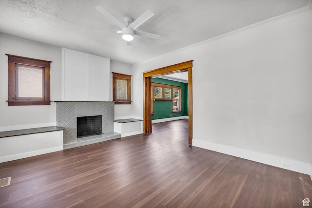 2546 S Fowler, Ogden, UT 84401 - unfurnished living room featuring a fireplace, dark wood finished floors, ornamental molding, a textured ceiling, and ceiling fan