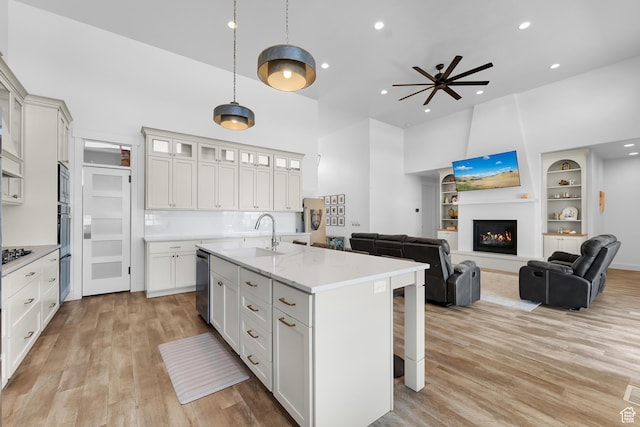 1872 S 250 W, Lehi, UT 84043 - kitchen with a kitchen breakfast bar, light wood-style flooring, a kitchen island with sink, recessed lighting, and built in features