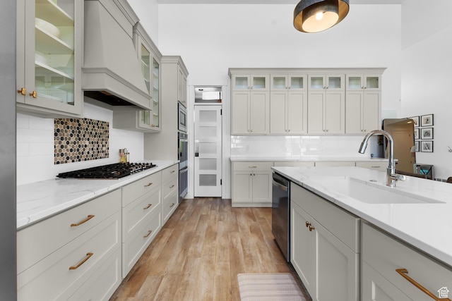 1872 S 250 W, Lehi, UT 84043 - kitchen with stainless steel appliances, premium range hood, backsplash, light wood-style floors, and light stone counters