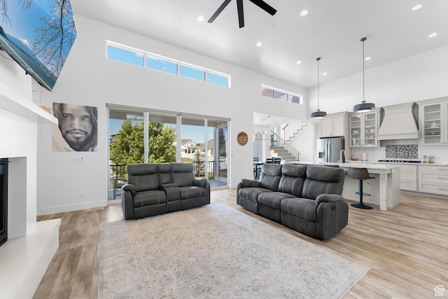 1872 S 250 W, Lehi, UT 84043 - living room featuring ceiling fan, stairway, a towering ceiling, recessed lighting, and plenty of natural light