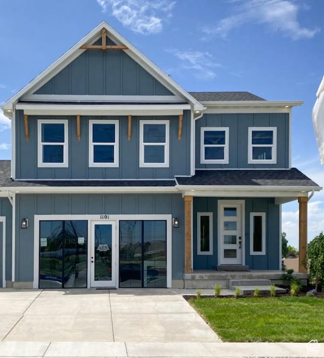 3644 N Eagle Meadows Dr Unit 307, Eagle Mountain, UT 84005 - view of front facade featuring board and batten siding, a porch, and a shingled roof